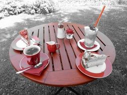 latte macchiato, coffee and cake on table outdoor