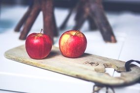 red apples on a wooden board