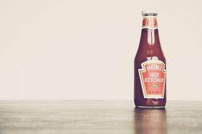 Red ketchup tomato sauce in a glass bottle