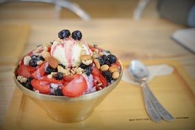 ice cream dessert with strawberries and nuts