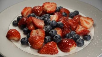 strawberries and blueberries with sugar
