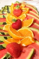 beautifully sliced fruit with strawberries on a dish