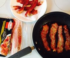 Fried bacon on the frying pan