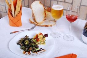 food, wine and beer on a table at restaurant