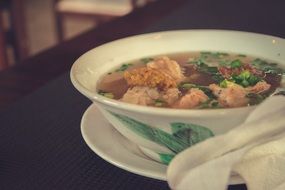 traditional asian soup with dumplings and chicken