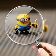 clipart of funny minion toy through magnifying glass