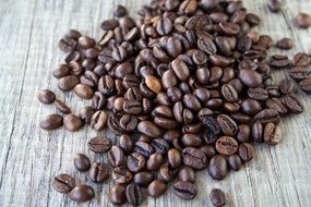 roasted coffee beans on a gray surface