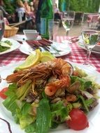 seafood salad on a white plate in restaurant