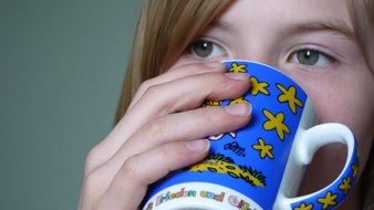 blue cup near the face