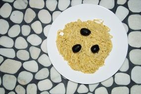 pasta with black olives on a plate