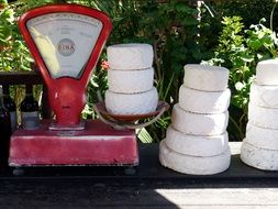 cheese heads on vintage weigh scale outdoor