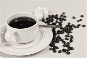 Black coffee in a cup and coffee beans