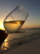 glass of wine at sunset, greece, santorini