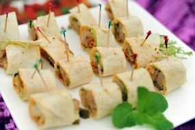 snack in the form of rolls on a white plate