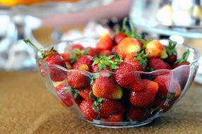 ripe strawberries in a transparent bowl