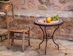 vintage chair at round table with fruits, relaxation