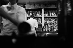 alcoholic drinks on a shelves in a bar