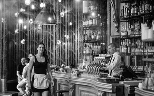 monochrome picture of pretty waitress in bar interior