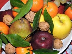 juicy tasty fruits on a white plate close up