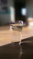 glass with water indoor, blurred background