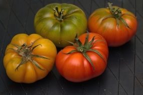 four unripe tomatoes