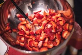 sliced strawberries in a metal bowl