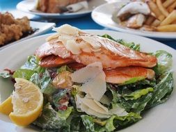 salmon on lettuce leaves with lemon