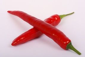 two red peppers lie in the shape of a cross