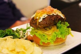 meat burger with chips in a restaurant