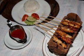 appetizer on skewers with sauce