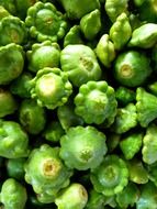 green pumpkin on a heap