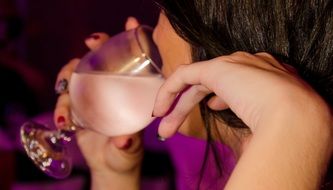 Drinking woman on a party close-up