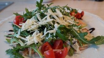 delicious salad with arugula parmesan and tomatoes