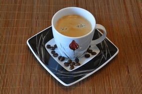 a cup of coffee with coffee beans