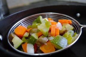 blanched vegetables in a sieve