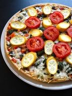 Vegetarian pizza with tomatoes and zucchini