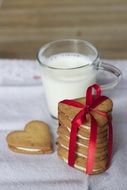 glass of milk and heart shaped cookies for valentines day