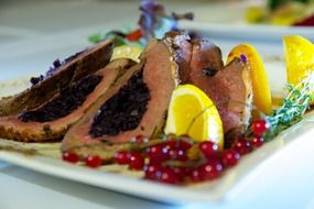 fried meat with red currant and lemon