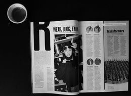 a cup of coffee and a fashion magazine on the table