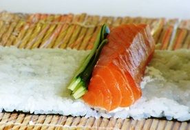 salmon sushi on bamboo mat