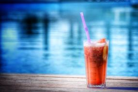 cocktail in a glass on the background of the pool