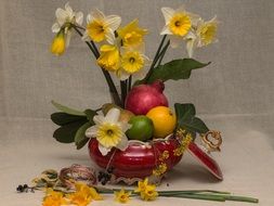 tropical fruits and daffodils as a still life