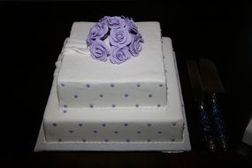 white cake with purple roses