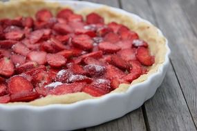 delicious cake with strawberries on the table