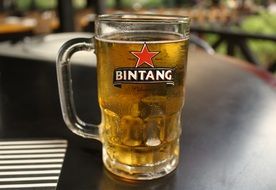 cold beer in mug on table