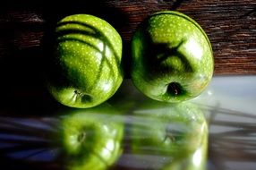 two green apples side by side