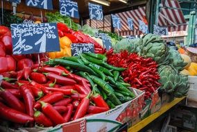 different peppers and other food on market stall