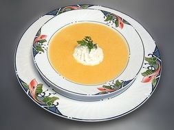 delicious carrot cream soup poured in a beautiful dish