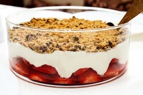 sweet dessert with strawberry yogurt and muesli lies in a bowl