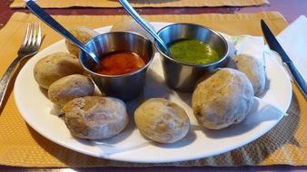 potatoes with colorful sauces on the plate